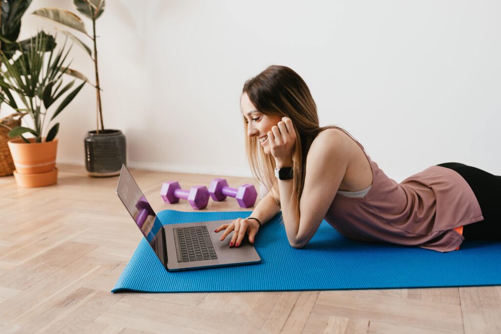 Woman with Computer on Yoga Mat Pexels min scaled